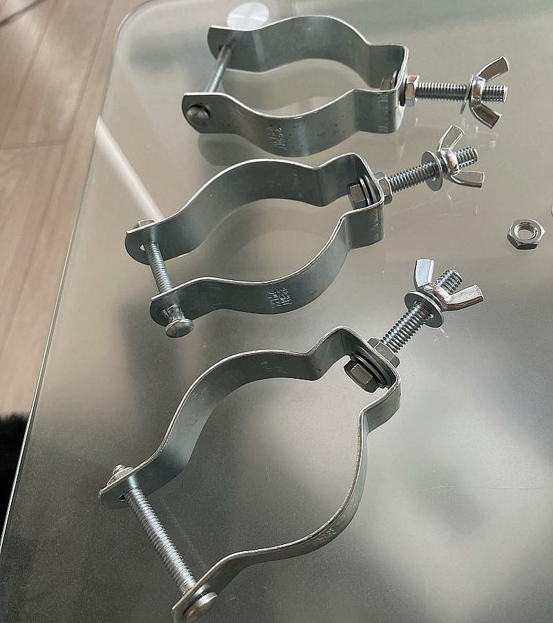 Three (3) conduit hangers with bolt, washer and nut assembly.